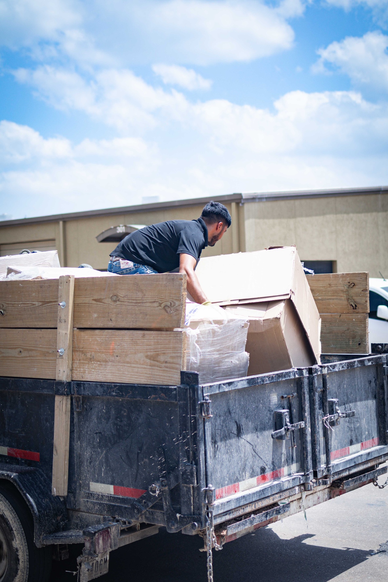 Green River crew loading a full trailer for a junk haul in Austin