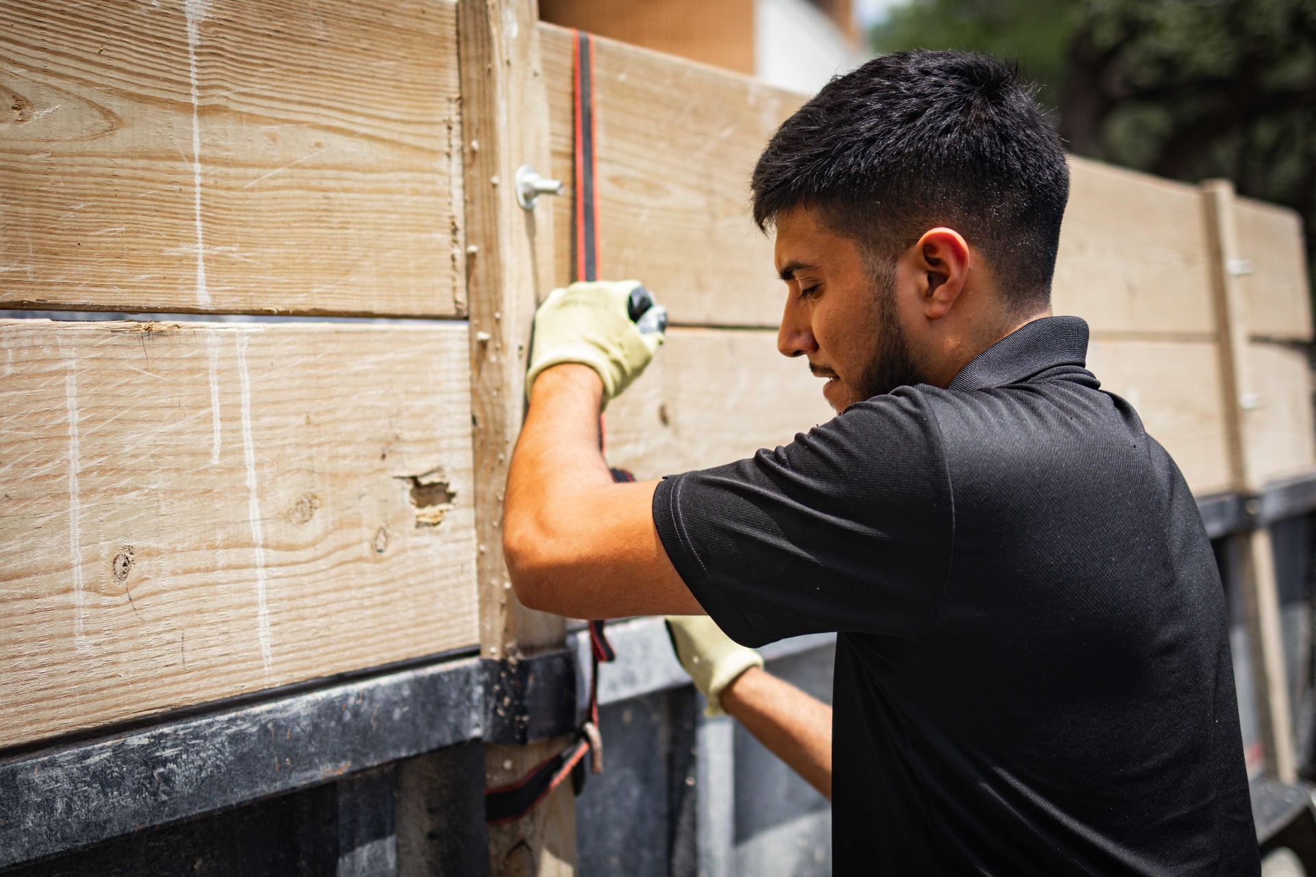 Crew member strapping down a loaded trailer